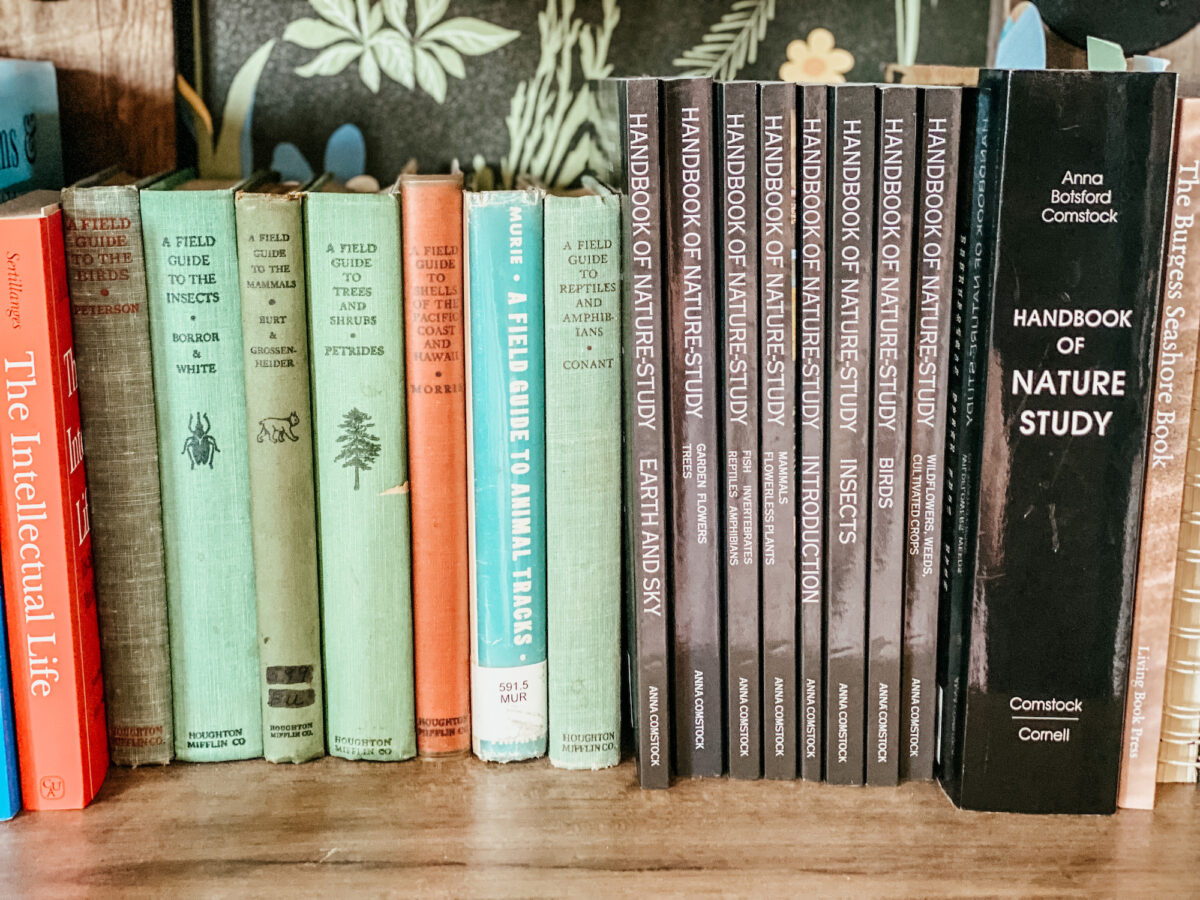 a variety of nature books on a bookshelf. 