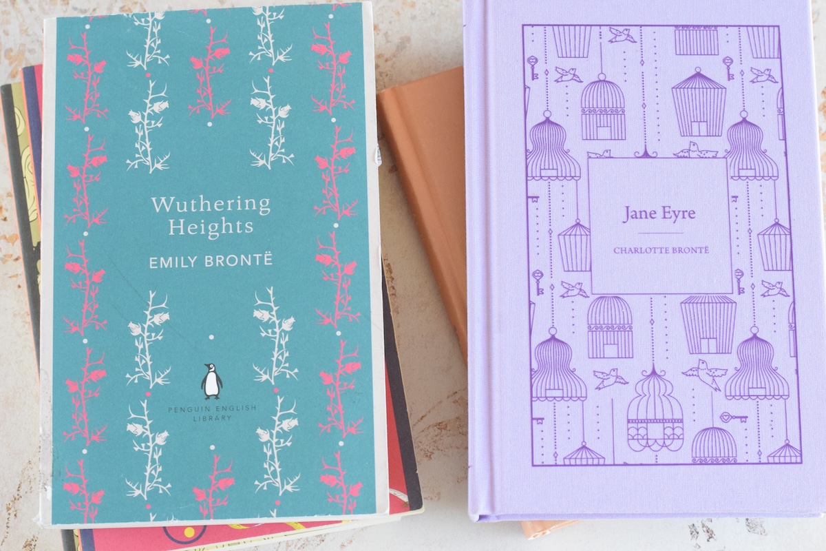 two stacks of classical books with Wuthering Heights and Jane Eyre on the top. 