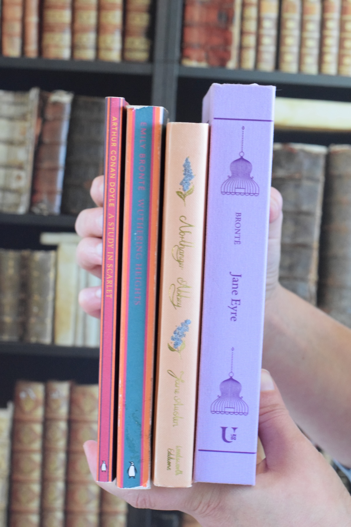 holding a few favorite cozy fall books.