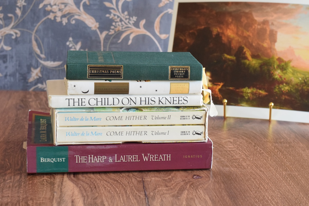 stack of poetry books on the table as part of the morning time basket.