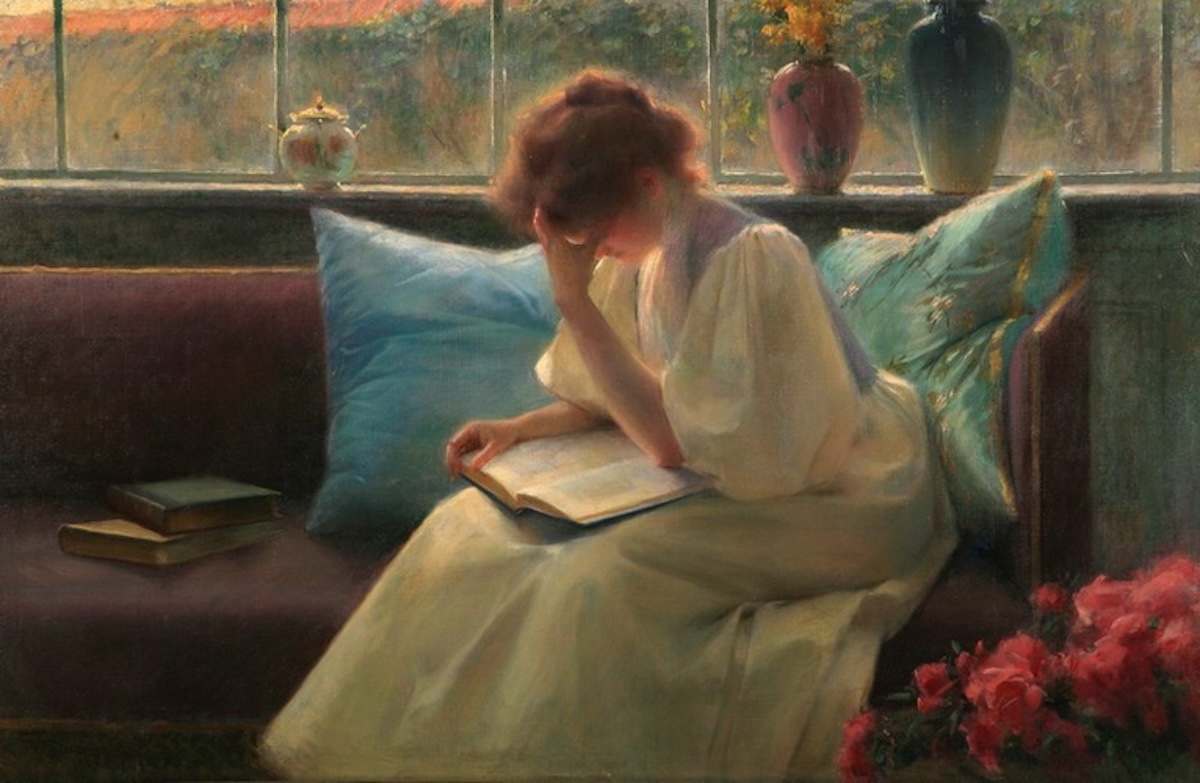 Painting of a lady reading on a sofa.